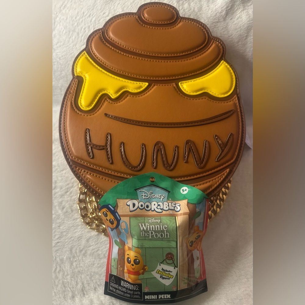 Disney x hunny skinny dip purse and Disney doorables Winnie the Pooh mini peek